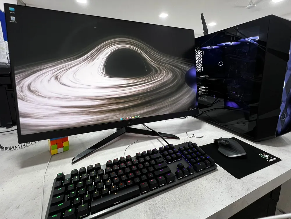 The founder's finished PC setup with an LG UltraGear monitor, Logitech keyboard and mouse